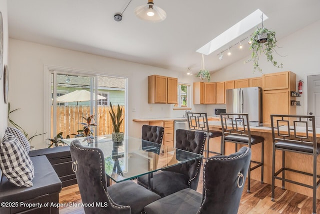 168 Current Dr, New Castle, CO 81647 - dining space with light wood-style floors, a skylight, and vaulted ceiling