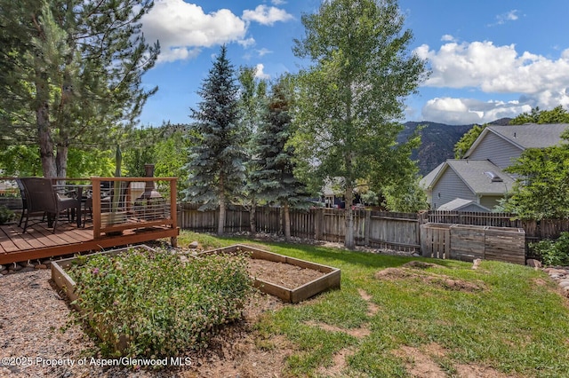 168 Current Dr, New Castle, CO 81647 - fenced backyard with a garden and a deck with mountain view