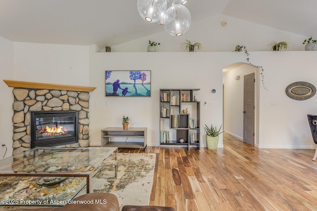 168 Current Dr, New Castle, CO 81647 - living area with arched walkways, wood finished floors, a fireplace, and high vaulted ceiling
