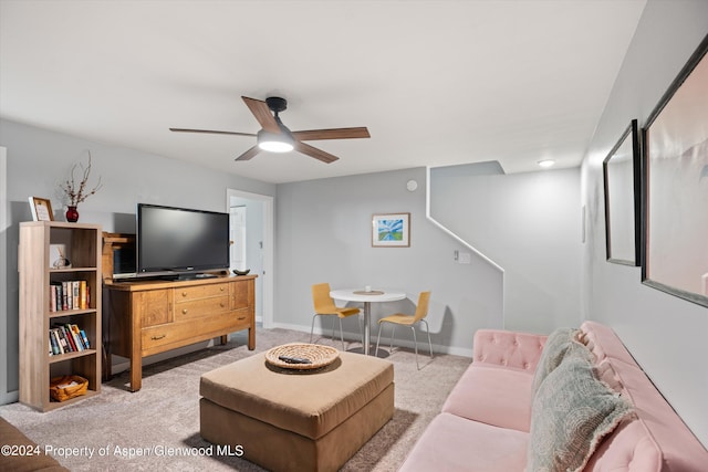 living room with ceiling fan and light colored carpet