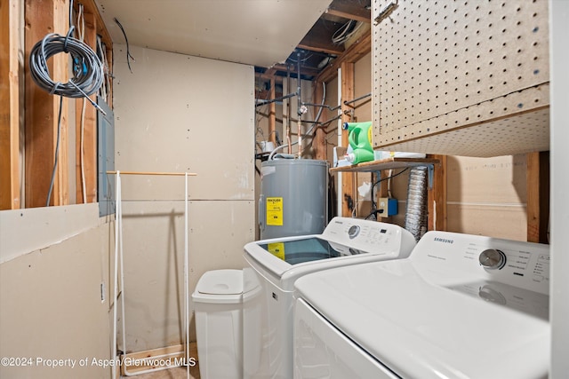 laundry room featuring electric water heater and washing machine and clothes dryer