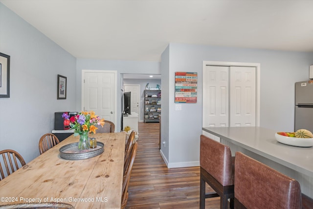 dining space featuring dark wood-type flooring