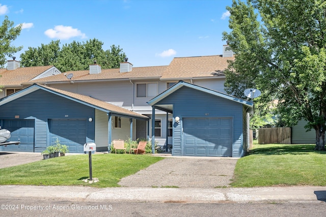 view of front property with a front yard and a garage