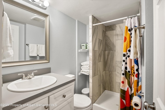 bathroom with a shower with curtain, vanity, and toilet