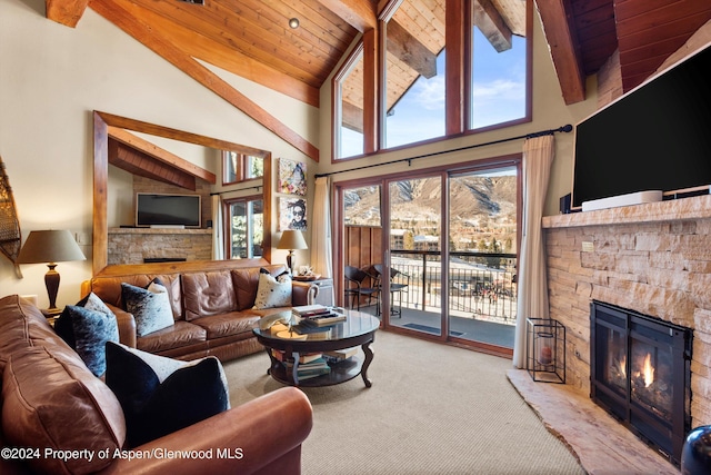 living room featuring a fireplace, beam ceiling, high vaulted ceiling, and plenty of natural light