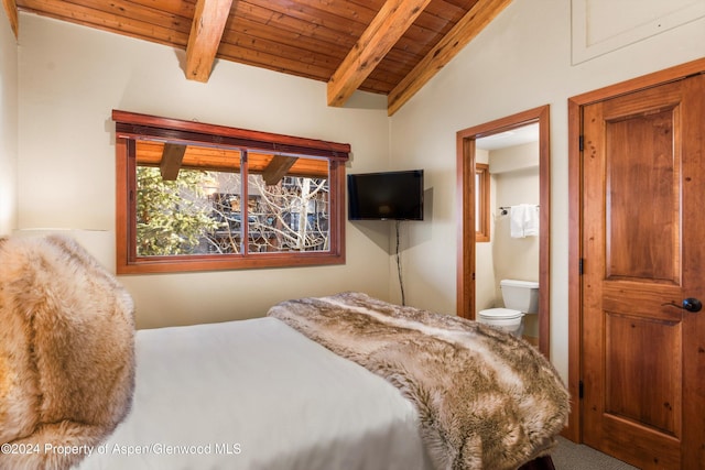 bedroom featuring lofted ceiling with beams, wood ceiling, and ensuite bath