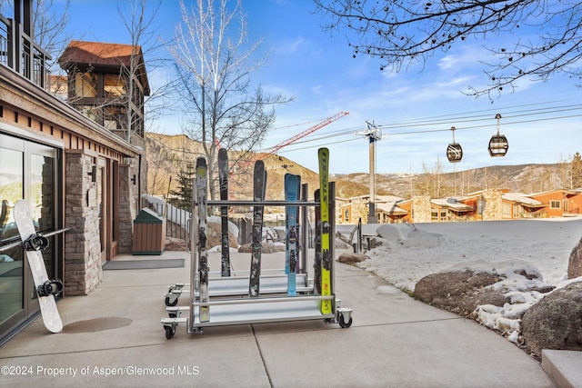 snow covered patio featuring a mountain view