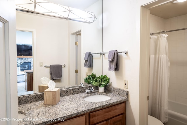 full bathroom with decorative backsplash, shower / bath combination with curtain, vanity, and toilet