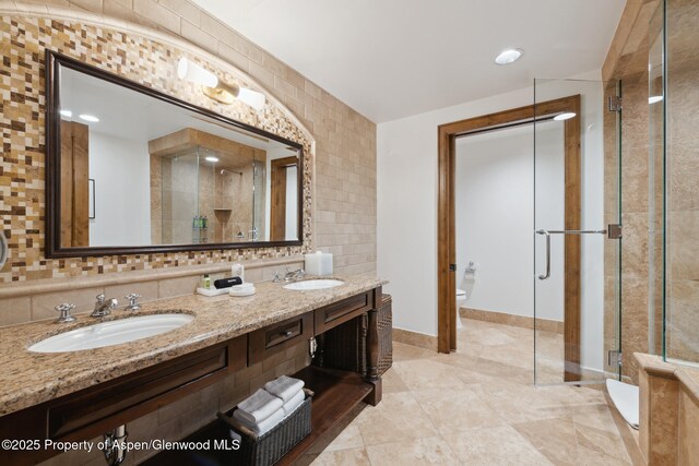 415 E Dean St Week 31, St, Aspen, CO 81611 - bathroom featuring vanity, a shower with shower door, tile walls, and toilet