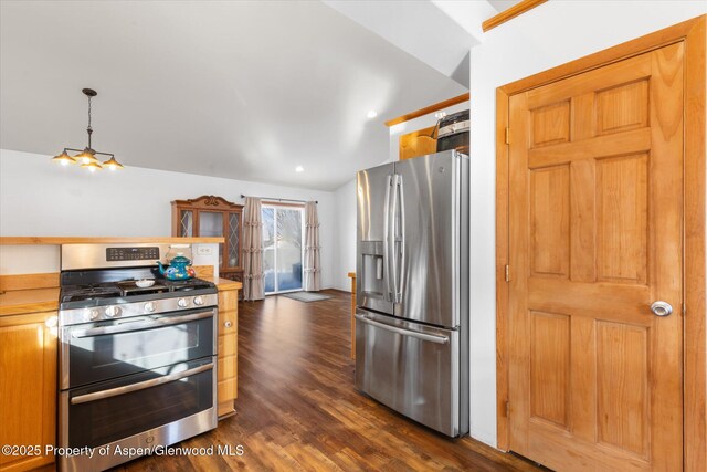 kitchen featuring decorative light fixtures, lofted ceiling, dark hardwood / wood-style flooring, and stainless steel appliances