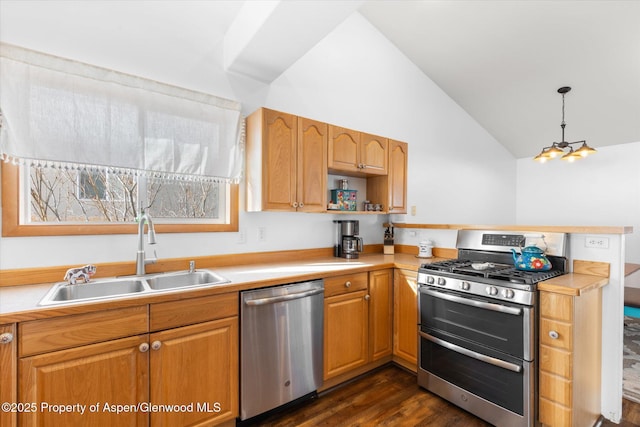 kitchen featuring appliances with stainless steel finishes, dark hardwood / wood-style floors, high vaulted ceiling, pendant lighting, and sink