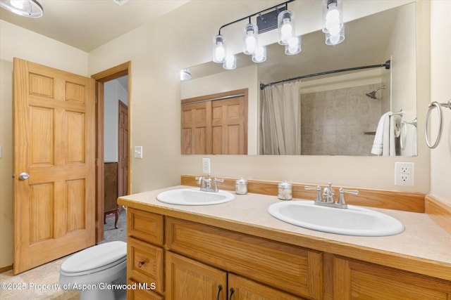 bathroom with tile patterned floors, toilet, vanity, and a shower with shower curtain