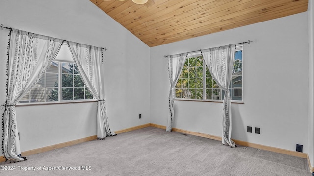 empty room featuring carpet, vaulted ceiling, and wood ceiling