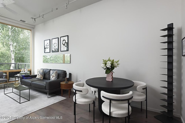 dining area featuring visible vents, track lighting, and dark wood-type flooring