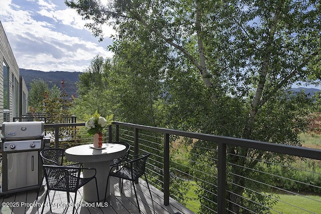 balcony featuring a mountain view and grilling area