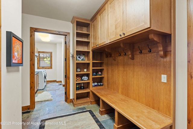 4034 Crystal Bridge Dr, Carbondale, CO 81623 - mudroom with washer and clothes dryer, stone tile flooring, and baseboards