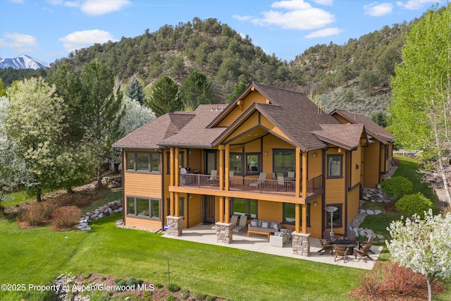 4034 Crystal Bridge Dr, Carbondale, CO 81623 - back of property with a patio area, outdoor lounge area, a lawn, and a mountain view
