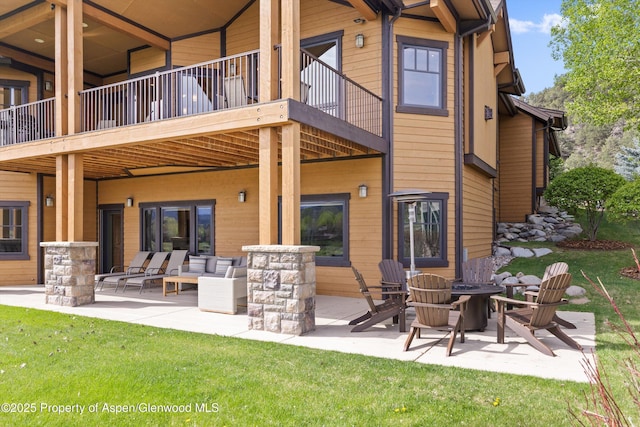 4034 Crystal Bridge Dr, Carbondale, CO 81623 - back of house featuring a patio, a fire pit, a yard, and a balcony
