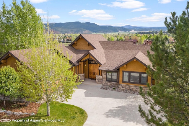 4034 Crystal Bridge Dr, Carbondale, CO 81623 - view of front of property with stone siding, a mountain view, and roof with shingles