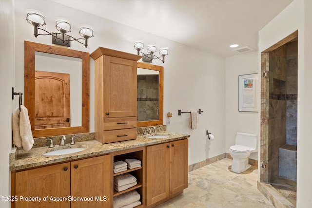 4034 Crystal Bridge Dr, Carbondale, CO 81623 - bathroom featuring toilet, baseboards, double vanity, and tiled shower
