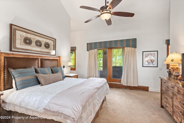 bedroom with light carpet, high vaulted ceiling, and ceiling fan