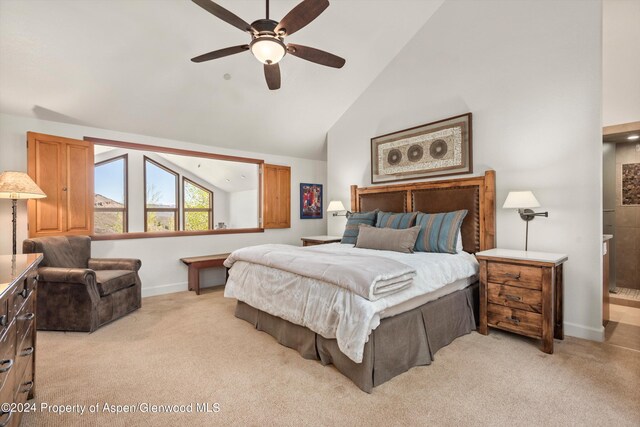 bedroom with light carpet, ensuite bathroom, high vaulted ceiling, and ceiling fan