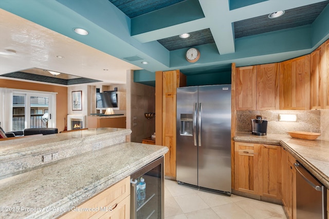 kitchen with light tile patterned floors, beamed ceiling, stainless steel appliances, beverage cooler, and decorative backsplash