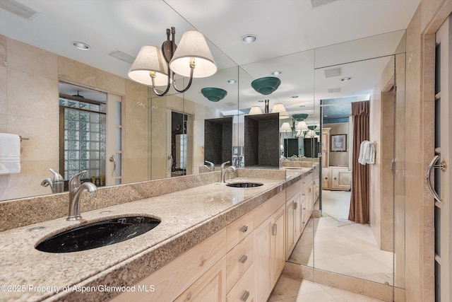 bathroom with vanity and tile walls