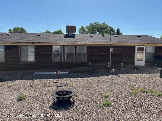 1598 N Yampa Ave, Craig, CO 81625 - back of property with a fire pit and roof with shingles