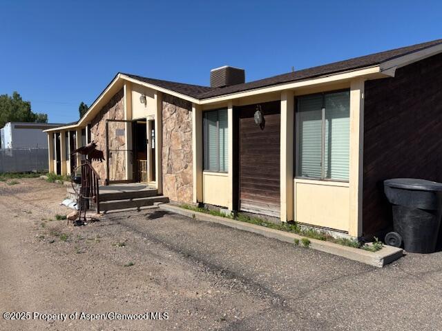 1598 N Yampa Ave, Craig, CO 81625 - view of property exterior with a chimney and stone siding