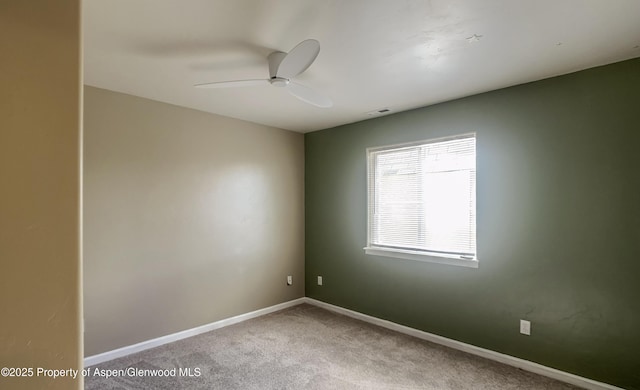 empty room with carpet flooring and ceiling fan