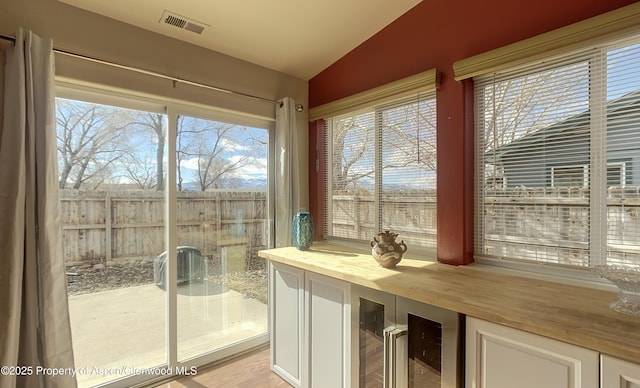 unfurnished sunroom featuring lofted ceiling