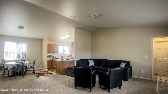 carpeted living room with lofted ceiling