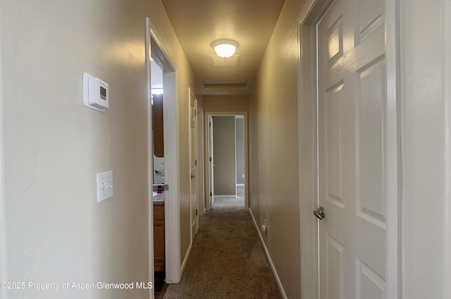 corridor featuring dark colored carpet