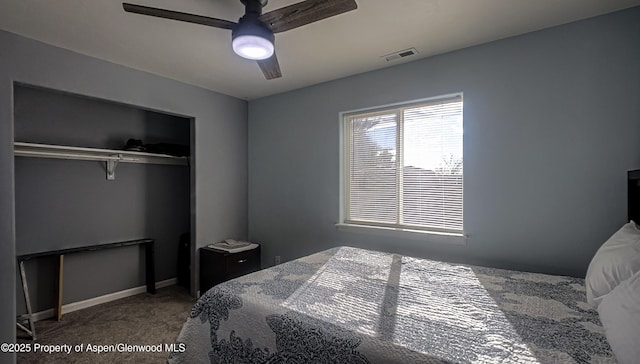 bedroom with ceiling fan, carpet floors, and a closet