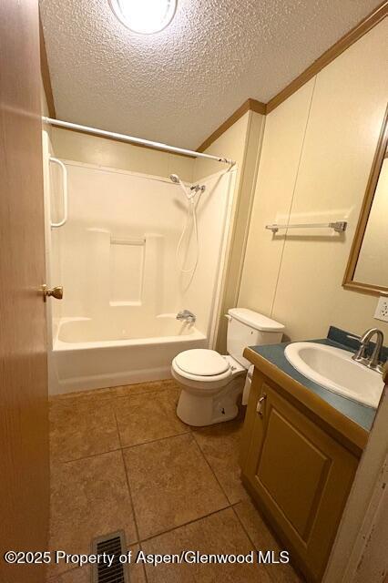 full bath featuring visible vents, toilet, a textured ceiling,  shower combination, and vanity