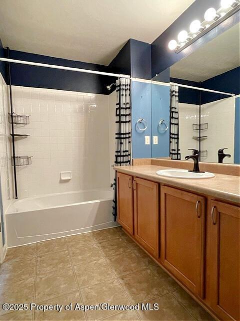 bathroom with vanity, tile patterned flooring, and washtub / shower combination