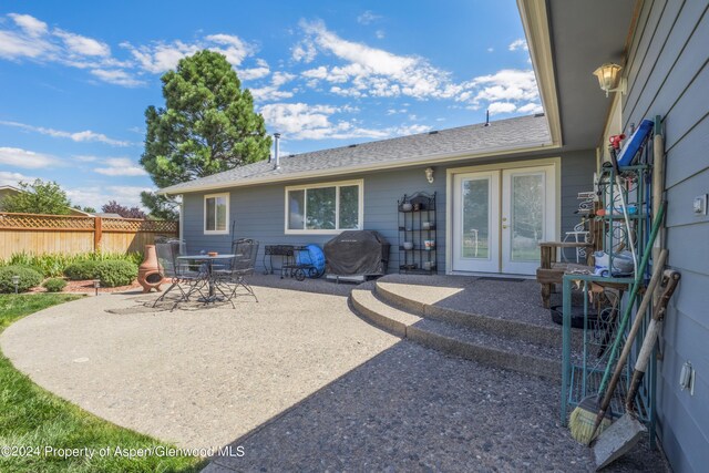 rear view of house with french doors and a patio area