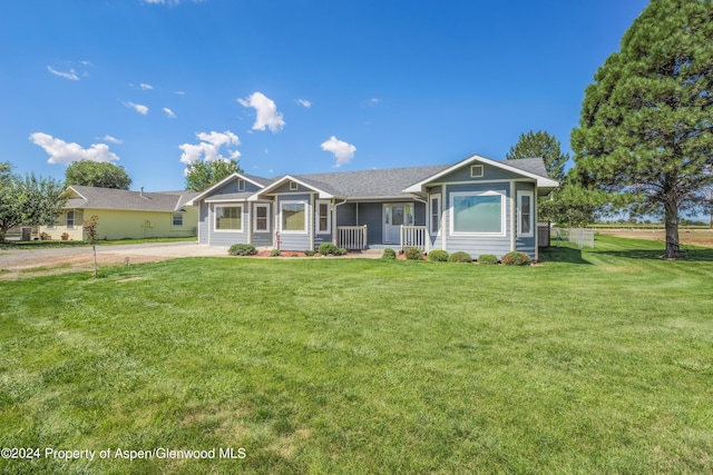 ranch-style home with a porch and a front yard