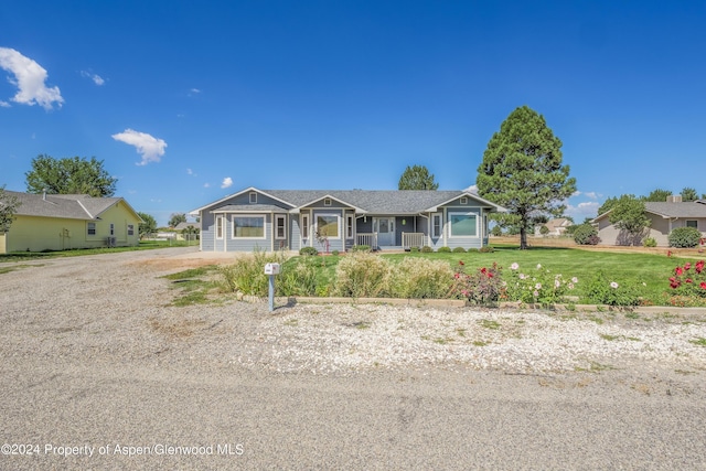 single story home featuring a front yard and covered porch