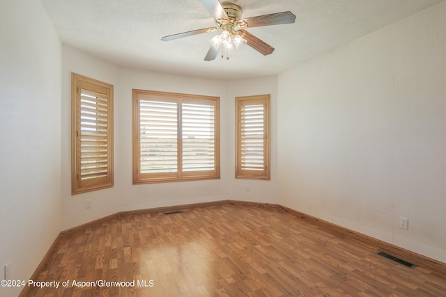 spare room featuring ceiling fan and wood-type flooring