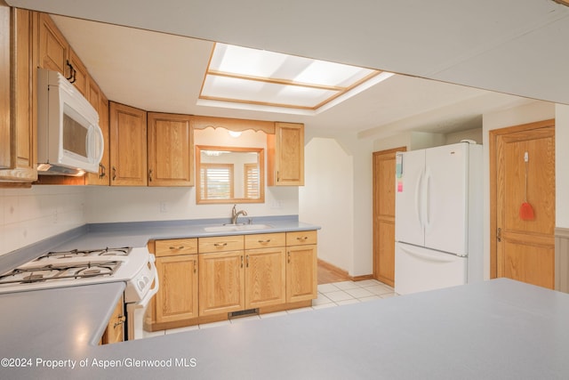 kitchen featuring light tile patterned floors, white appliances, tasteful backsplash, and sink