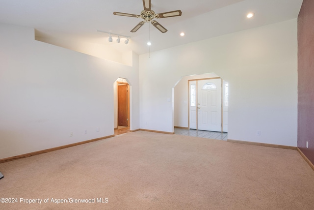 unfurnished room featuring ceiling fan, rail lighting, and light carpet