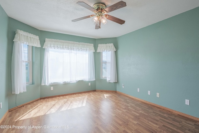 unfurnished room featuring ceiling fan and hardwood / wood-style floors