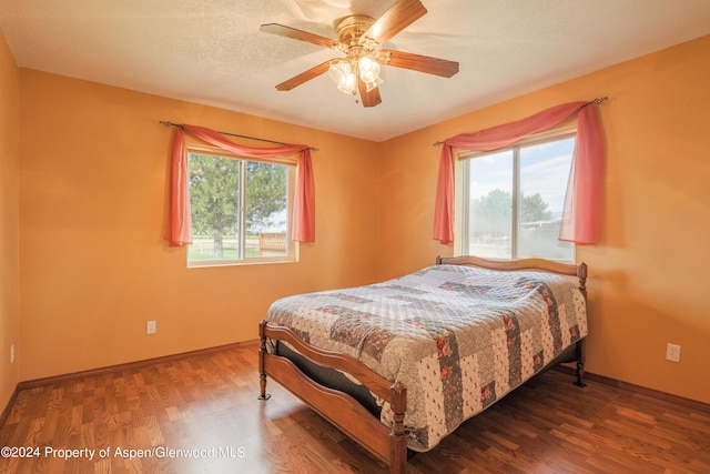 bedroom featuring hardwood / wood-style floors and ceiling fan