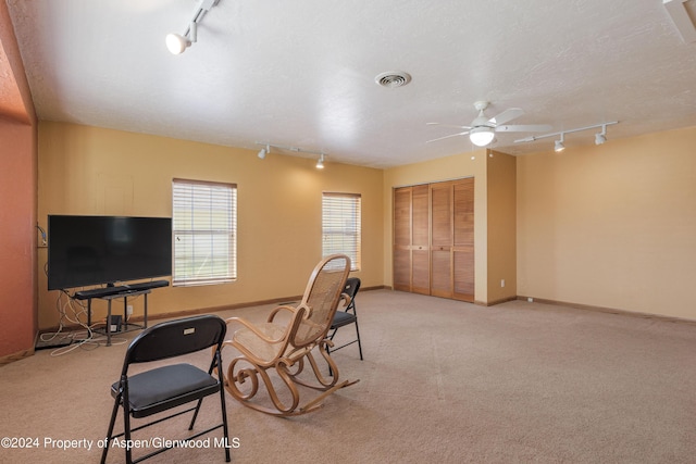 office area with a textured ceiling, light colored carpet, ceiling fan, and rail lighting