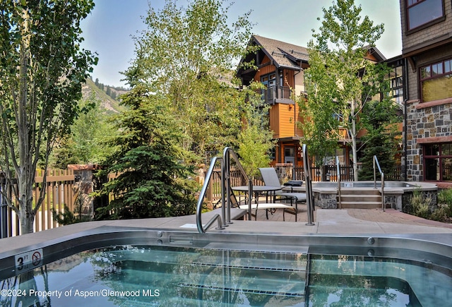 view of swimming pool with a patio area and sink