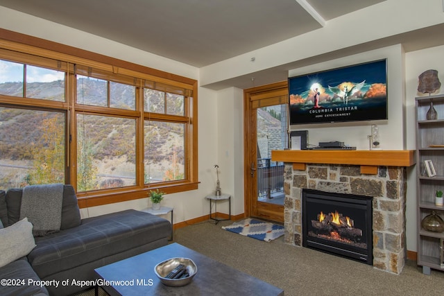 carpeted living room featuring a fireplace and a wealth of natural light