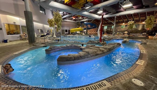 view of pool featuring a patio area and an in ground hot tub