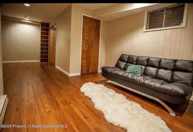 681 S 2nd St Unit G, Carbondale, CO 81623 - living area featuring wooden walls, wood finished floors, baseboards, and a baseboard heating unit